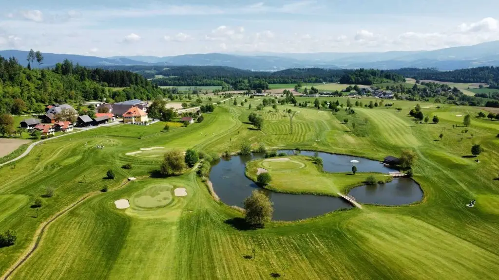 a golf course with water in the middle